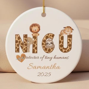 May include: A round, white ceramic ornament with the letters "NICU" in a giraffe print design, each letter adorned with a cute animal. The ornament includes the text "Protector of tiny humans", a name, and the year 2025.