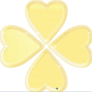 Pode incluir: Um trevo de quatro folhas amarelo com um design costurado.