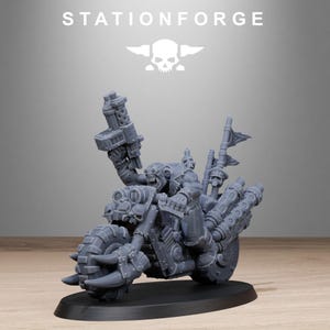 May include: A gray miniature motorcycle with a menacing rider, featuring a large gun and skull details. The text "STATIONFORGE" is displayed above the motorcycle. The model is on a black base.