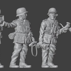 May include: Four grey miniature figures of soldiers in uniform, each with a different pose and equipment. One figure holds a camera, another a rolled-up blanket, and two others hold a pipe and a rifle. The figures are detailed and appear to be historical.