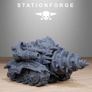May include: A grey model of a war machine with a drill-like front, tank treads, and a spiked exterior. The text "STATIONFORGE" and a skull logo are visible above the model.