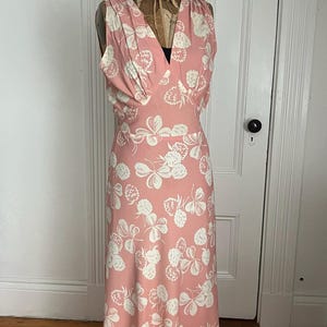 Beautiful floral bias cut full length dress with tie back. Rayon