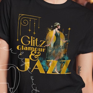 May include: Black t-shirt with the words "Giltz, Glamour & Jazz" in gold and teal. The shirt features an art deco illustration of a woman in a flapper dress. The background shows a jazz band playing.