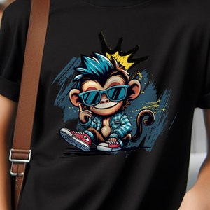 May include: A black t-shirt with a graphic of a cartoon monkey wearing sunglasses and a crown. The monkey is wearing a blue and white plaid shirt and red sneakers.