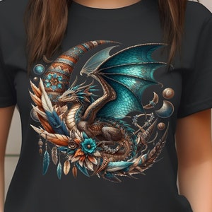 This short-sleeved t-shirt features a vivid dark boho mystical dragon in turquoise and brown hues, on a crescent moon adorned with feathers, pocket watches and planets. The large design is centered on the front of the t-shirt.