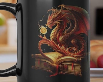May include: Black ceramic mug with a detailed illustration of a red and gold dragon on an open book. The dragon has outstretched wings and holds a glowing orb. The mug has a large handle and is on a wooden surface. The mug is suitable for hot drinks.