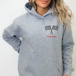 May include: A gray hooded sweatshirt with a checkered flag graphic and the text "Formula One" in red.