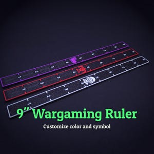 May include: Three 9-inch wargaming rulers with textured black surfaces and colored borders in purple, red, and white. Each ruler features white measurement markings from 1 to 9 inches and a unique icon at the 4-inch mark: a cat, a skull, and a helmet.