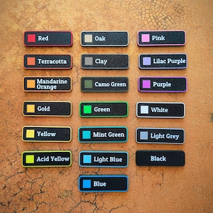 May include: A collection of rectangular color swatches, each labeled with a color name. Colors include red, orange, yellow, green, blue, and purple, among others. The swatches have black backgrounds and colored borders.