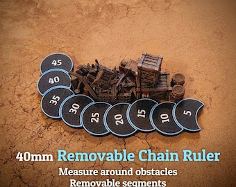 May include: A 40mm removable chain ruler featuring black circular segments with white numbers from 5 to 45, each with a light blue border. The set includes a miniature brown wooden crate and barrel terrain piece for measuring around obstacles.