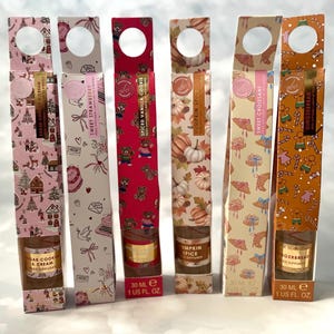 May include: Six reed diffusers in patterned boxes with different scents. Scents include Sugar Cookie & Cream, Sweet Strawberry, Spiced Vanilla Cookie, Pumpkin Spice, Sweet Croissant, and Gingerbread. Each box contains 30 ml (1 fl oz).