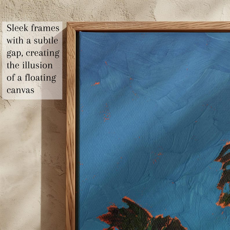 May include: A framed abstract painting with a blue background and orange accents. The wooden frame has a subtle gap, creating the illusion of a floating canvas. The text in the image reads: Sleek frames with a subtle gap, creating the illusion of a floating canvas.