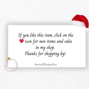 May include: A white card with text, a red heart icon, and a Santa hat. The text reads: "If you like this item, click on the icon for new items and sales in my shop. Thanks for shopping by!" A clear ornament is in the lower left.