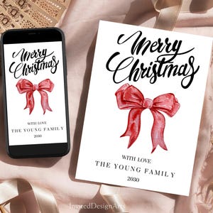 May include: A white Christmas card and a smartphone display the words "Merry Christmas" in elegant script, above a watercolor-style red bow. The card and phone also include the text "With Love, The Young Family, 2030."