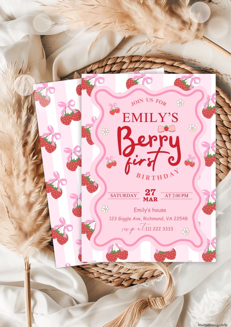 May include: Pink and white striped invitation with a pink and white strawberry pattern. The invitation says "Join us for Emily's Berry First Birthday" with a date of Saturday, March 27th at 2:00 PM. The invitation also includes an address and phone number.