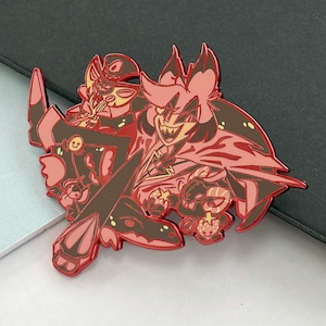 May include: A red and brown enamel pin featuring two cartoon characters with sharp teeth and expressive faces. The pin has a detailed design with a glossy finish, perfect for collectors or fans of animation.