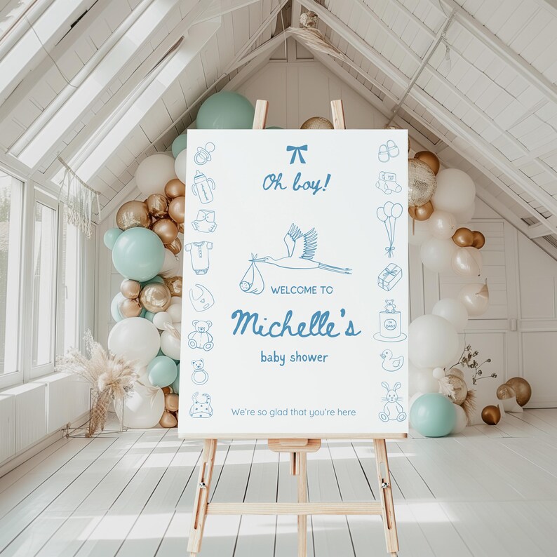 May include: A white welcome sign with blue text and illustrations for a baby shower. The sign says "Oh boy!" and "Welcome to Michelle's baby shower. We're so glad that you're here."