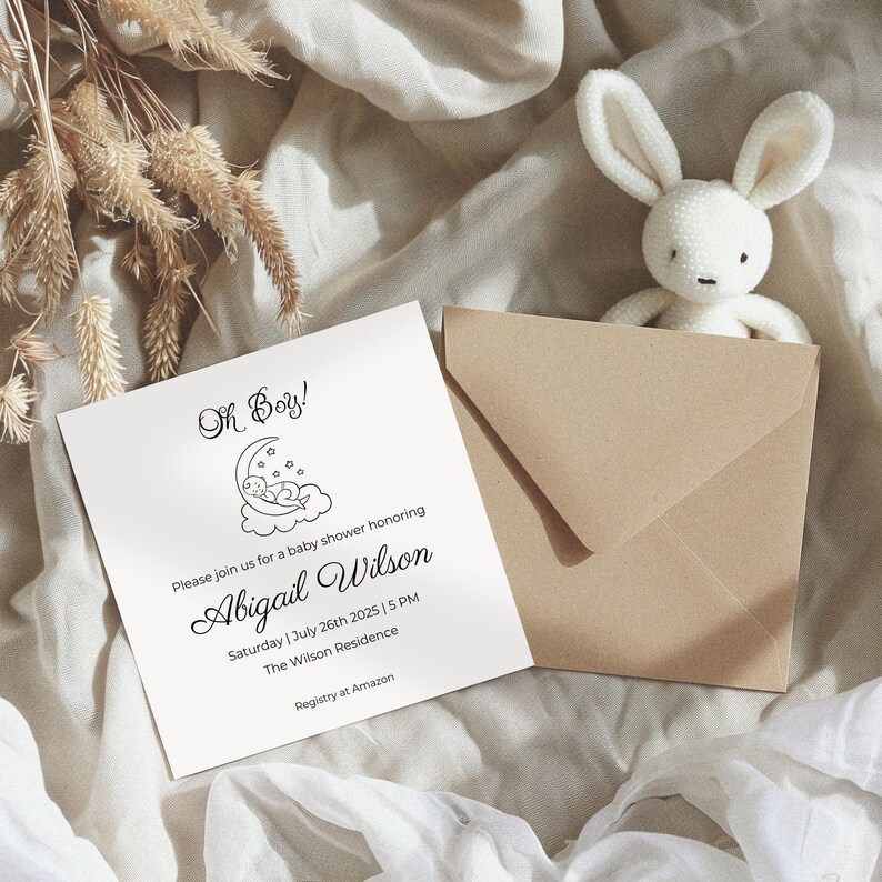 May include: A white card with black text announcing a baby shower for Abigail Wilson. The card features a simple illustration of a baby sleeping on a crescent moon. The text reads "Oh Boy!" and includes the date, time, and location of the shower. The text also includes the phrase "Registry at Amazon".