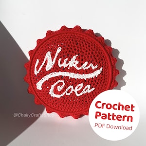 May include: A red crochet coaster featuring the words "Nuka Cola" in white. The coaster has a scalloped edge and is a crochet pattern download. The image also includes the text "Crochet Pattern .PDF Download".