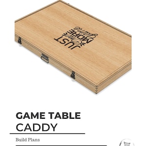 May include: A wooden box with a hinged lid and metal clasps. The box is labelled "Game Table Caddy" and "Just One More Game".