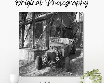 Original black and white photograph of a 1930s Ford Hot Road custom convertible parked at a car show in amongst trees at Bicester Heritage.