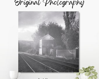 Original black and white photograph of a East Holmes signal box in Lincoln, taken on expired film, with sun flare in the distance.