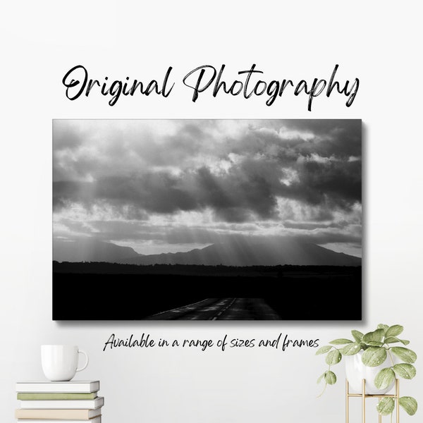 Original black and white photograph of sunlight breaking through stormclouds over Eryri (Snowdon) in Cymru (Wales).