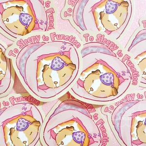 May include: A set of pink and white stickers featuring a cartoon hamster wearing a purple sleep cap and the text "To Sleepy to Function".