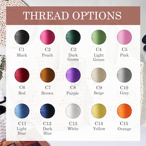 May include: Image displaying thread color options with the text "THREAD OPTIONS" at the top. The image shows 15 different thread colors, each labeled with a letter and color name, including black, peach, dark green, light green, pink, red, brown, purple, beige, grey, light blue, dark blue, white, yellow, and orange.