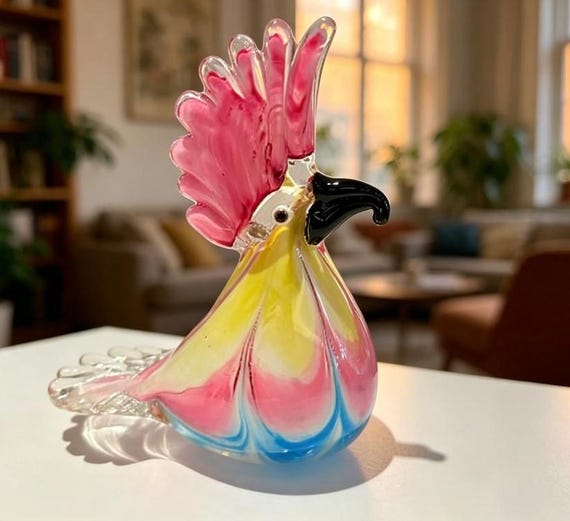 A hand-blown glass cockatoo with the kind of vivid, molten-color detail that makes you forget it's sitting on a shelf.