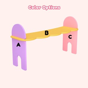 May include: A colorful, three-piece shelf unit with a cloud-shaped top. The supports are lavender and pink, and the shelf is yellow. The text "Color Options" is at the top. The shelf is designed for decorative or functional use.
