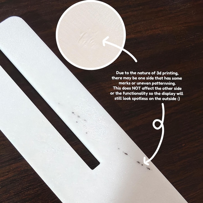 May include: Close-up of a white 3D-printed object with a rectangular shape and a cut-out section. The text in the image states that due to the 3D printing process, one side may have marks. The other side will look spotless.