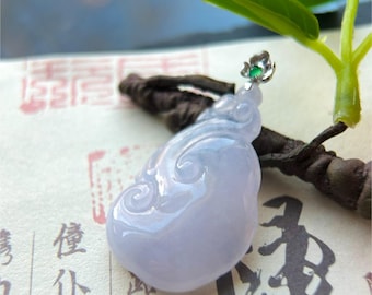 May include: A lavender jade pendant with a swirling design. The pendant is topped with a small silver flower with a green gemstone center. The background includes green leaves and Chinese characters.