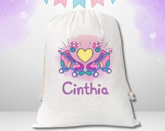 May include: White drawstring bag featuring a pink and purple roller skate design, two mushrooms, and a yellow heart. The bag is personalised with the name "Cinthia".