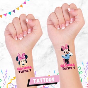 May include: Temporary tattoos featuring Minnie Mouse with a pink bow and the text "GIANNA Turns 1". The tattoos are on wrists, with a banner that says "TATTOOS". Colourful party decorations are in the background.