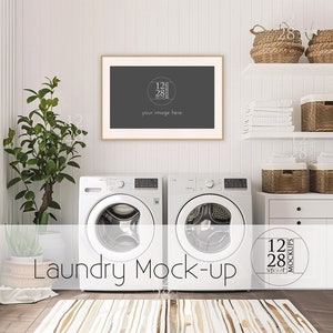 May include: A white laundry room with two white washing machines, a framed picture, and a white shelf with wicker baskets. The room has a white wood floor and a rug with a brown and white pattern.