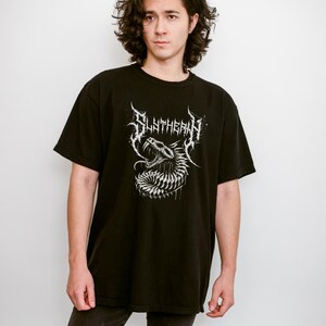 May include: A black t-shirt with a white graphic of a snake with the word "SLITHERIN" above it.
