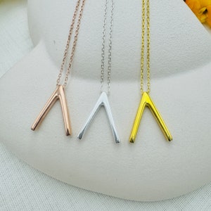 Può includere: Tre delicate collane con un semplice ciondolo a forma di V. Le collane sono disponibili in oro, argento e oro rosa.