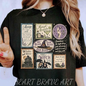 May include: A black t-shirt featuring a graphic print of multiple rectangular and circular postage-style stamps. The designs include text such as Always throw spilled salt, Midnight Margaritas, My Blood Your Blood Our Blood, and There's a little witch.