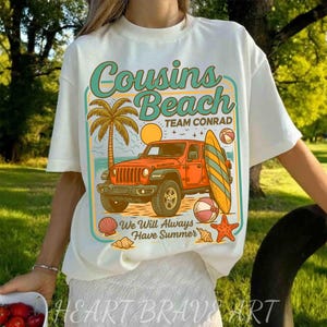 May include: White t-shirt with a beach-themed graphic. The design features an orange jeep, a surfboard, a palm tree, and the words "Cousins Beach Team Conrad" and "We Will Always Have Summer."
