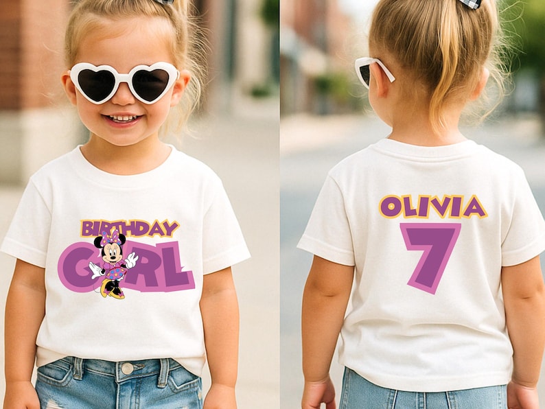 May include: A white short-sleeved t-shirt featuring a graphic of Minnie Mouse with the text Birthday Girl on the front. The back of the shirt displays the name Olivia in yellow letters above a large purple number 7 with a yellow outline.