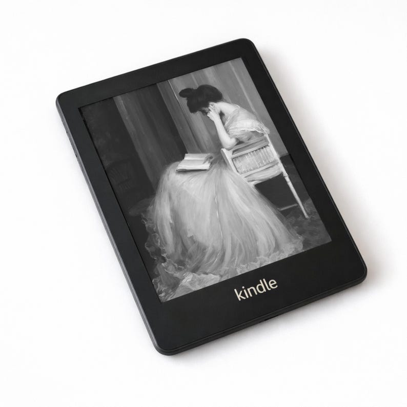 May include: Black Kindle e-reader displaying a grayscale image of a woman reading. The e-reader has a rectangular shape with rounded corners and the word "kindle" printed at the bottom. The screen shows a woman in a long dress.