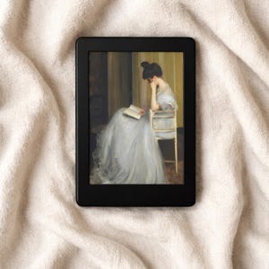 May include: A black e-reader displays a classical painting of a woman reading. The artwork features a woman in a long, light blue dress seated in a chair, engrossed in a book. The background has warm, golden tones.