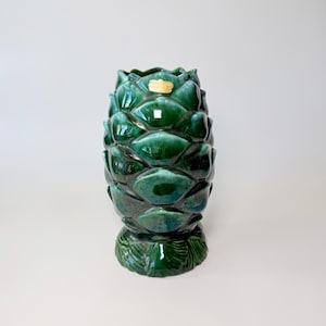 May include: A set of three ceramic mugs with a speckled, matte finish. The mugs are in shades of cream, light gray, and dark gray. Each mug has a simple, minimalist design, perfect for coffee or tea.