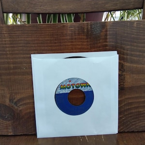 May include: A handmade wooden sign with the text "Welcome to our porch" in white lettering. The sign is rectangular, with a distressed finish, and features a small, decorative heart. The background is a light gray.