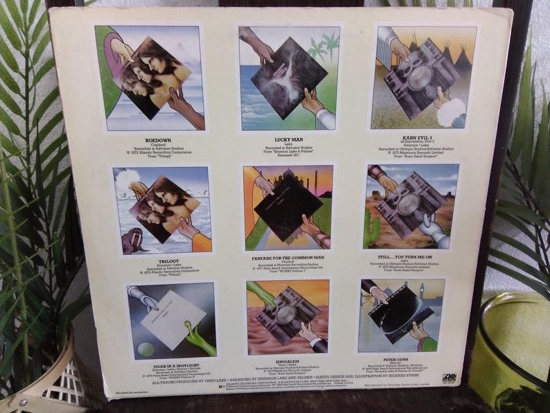 May include: Album cover featuring nine square illustrations of album art. Each illustration shows a hand holding the album. The album art includes images of people, landscapes, and abstract designs. Text is present on the album cover.