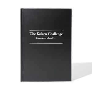 May include: A black hardcover book with the title "The Kaizen Challenge" and the subtitle "Greatness Awaits..." printed in white.