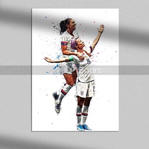 May include: Two female football players in white and blue kits celebrate scoring a goal. The player in the foreground is raising her arms in the air, while the player behind her has her arm around her teammate's shoulders. The background is a watercolour-style painting of colourful splashes.