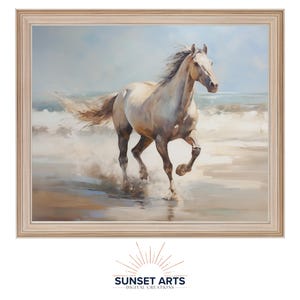 May include: A framed painting of a white horse running on a beach with waves crashing behind it. The painting has a light blue sky and a sandy beach.