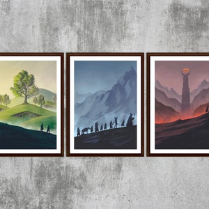 May include: A triptych of framed art prints featuring scenes from a fantasy setting. The first print shows a green landscape with hobbit holes and a large tree. The second depicts figures traversing a mountain range. The third shows a tower with an eye.